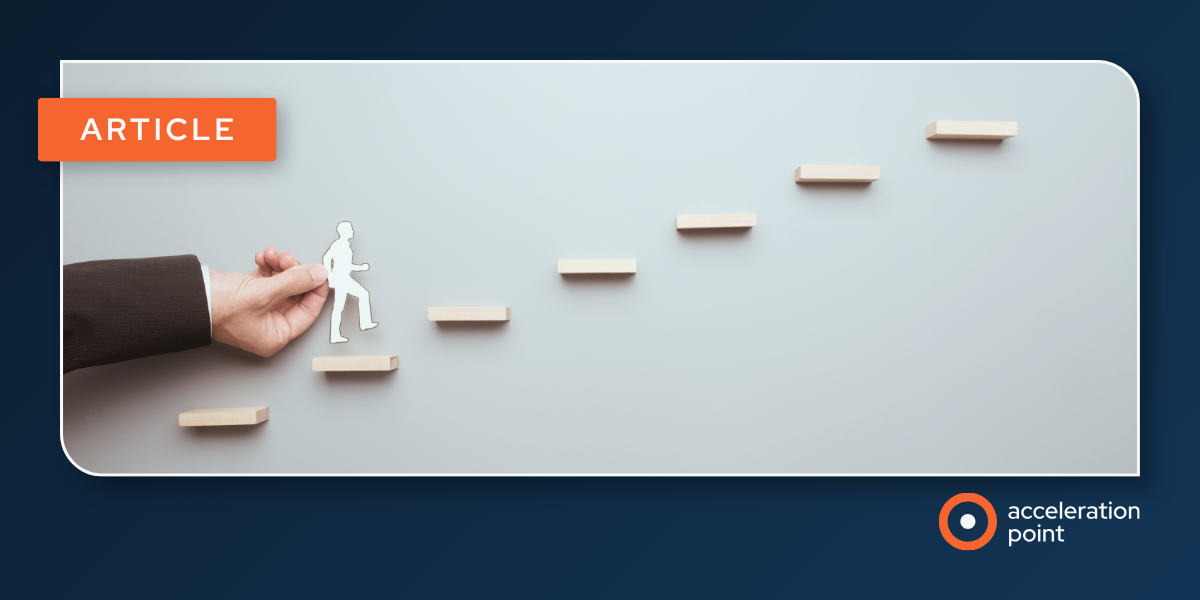 A hand guides a paper figure up ascending wooden steps, illustrating how Medical Affairs teams define and measure impact progress.