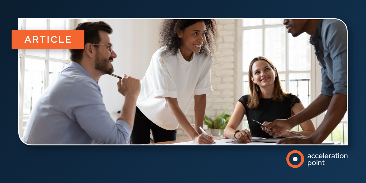 Four Medical Affairs colleagues collaborate around a table with notes and a pen in a bright office, representing the teamwork behind building digital-ready Medical Science Liaison skills.