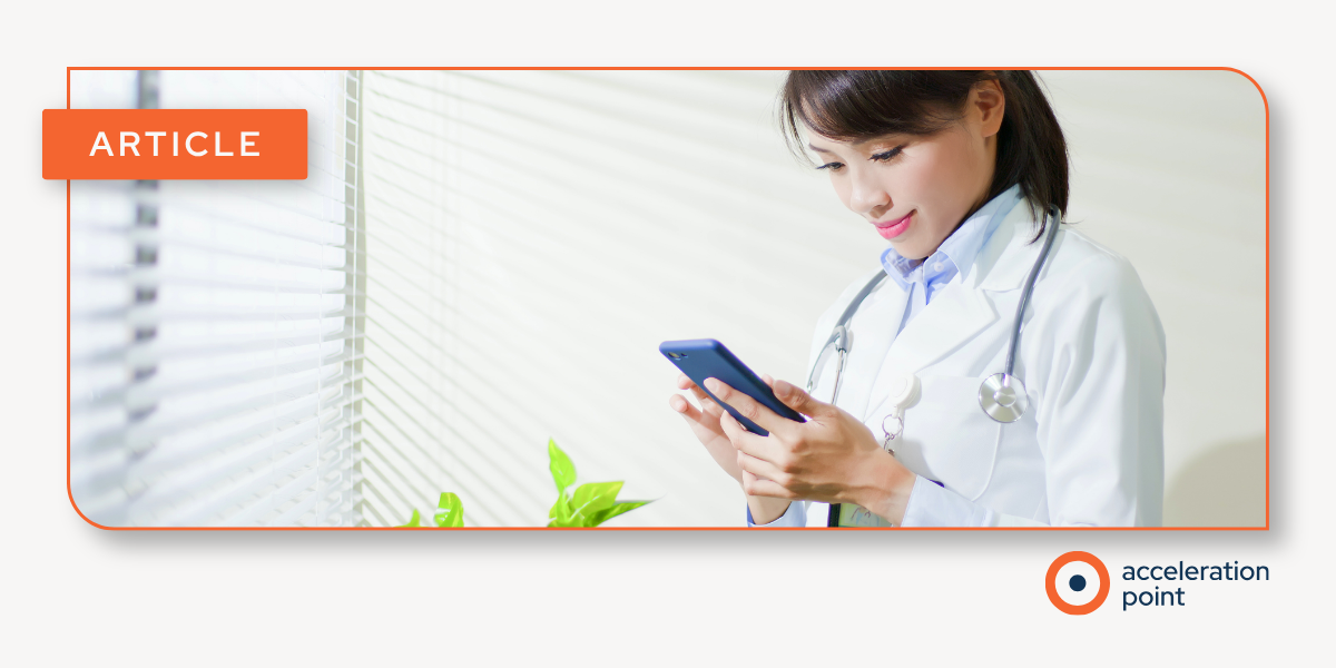 A physician in a white coat reads on a smartphone by a window, reflecting social listening as a real-time insight source for Medical Affairs teams.