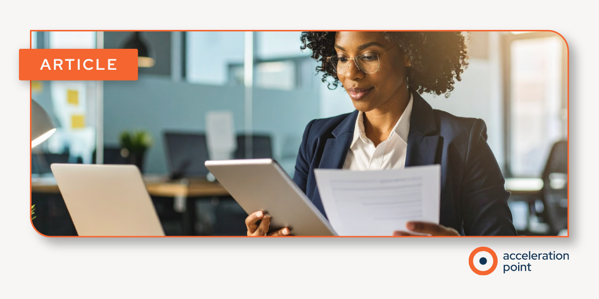 A professional reviews printed materials and a tablet at a desk in an office setting, representing the hands-on document review work central to a Medical Material Review process for Medical Affairs and Medical Operations teams.