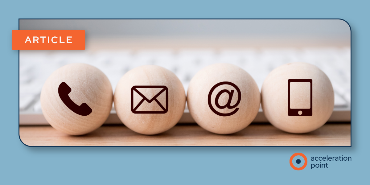Four wooden spheres marked with phone, email, and mobile icons near a keyboard, representing channels behind coordinated KOL engagement.