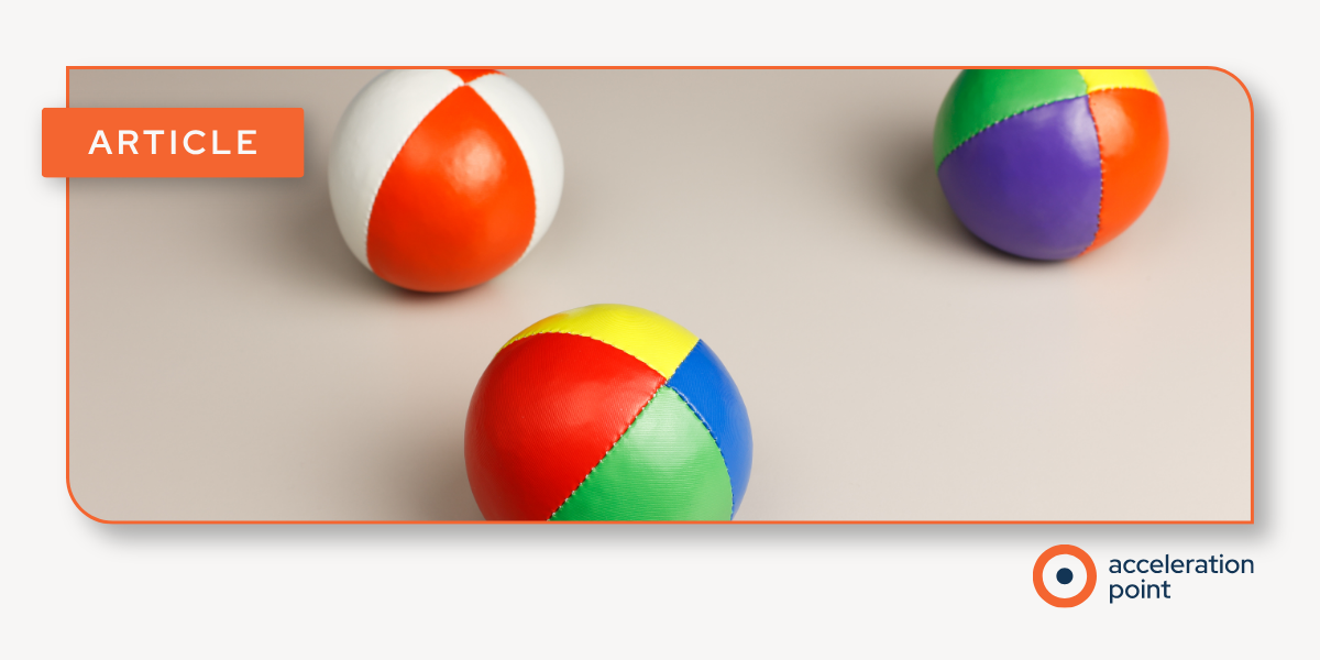 Three colorful juggling balls rest on a neutral surface, illustrating the balancing act of Medical Affairs staffing and flexible team capacity.