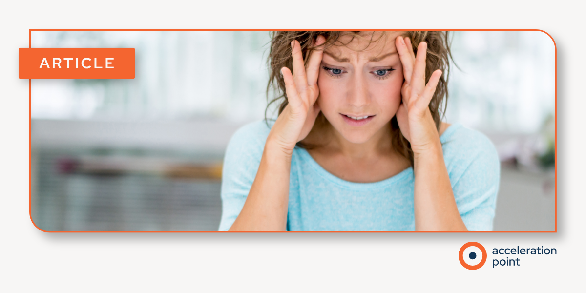A woman looks overwhelmed at her desk, evoking the challenge Medical Affairs teams face keeping up with 24/7 online scientific exchange.