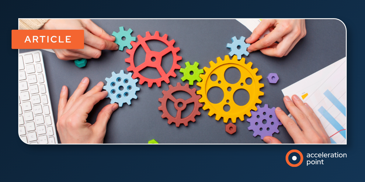 Hands assemble interlocking colored gears near charts and a keyboard, representing partners aligning KOL insight-sharing in co-commercialization.