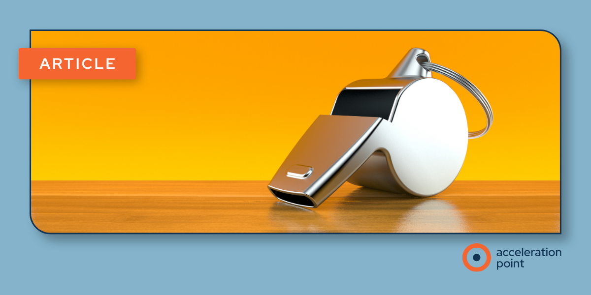 A chrome referee's whistle on a wooden surface signals coaching, illustrating coaching measures that help Medical Affairs teams improve KOL engagement.