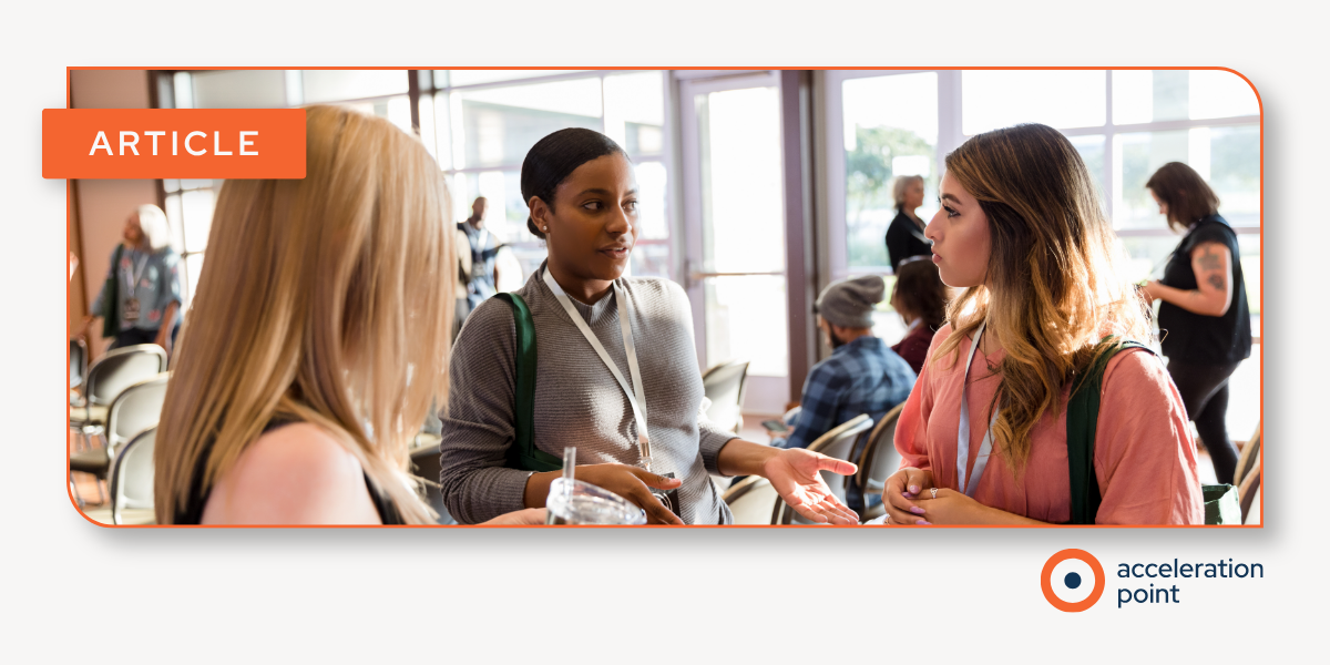 Three professionals with conference lanyards talk at a medical congress, reflecting the scientific exchange social listening captures online.